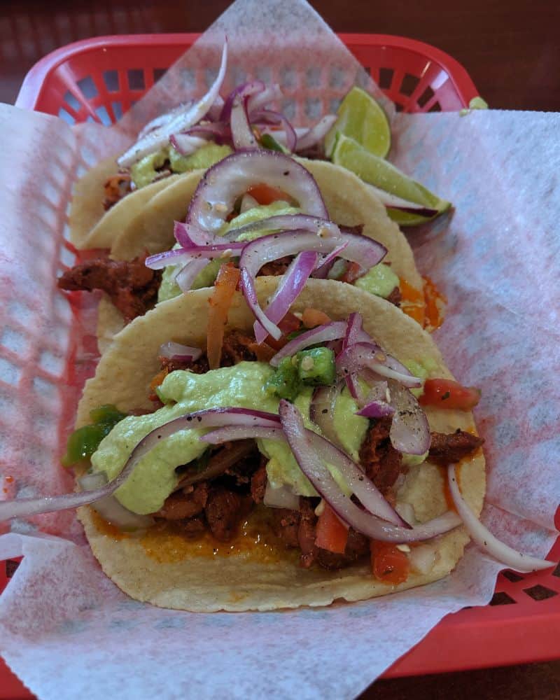 red basket with three tacos