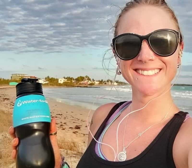 woman holding Water To Go water bottle with built-in filter