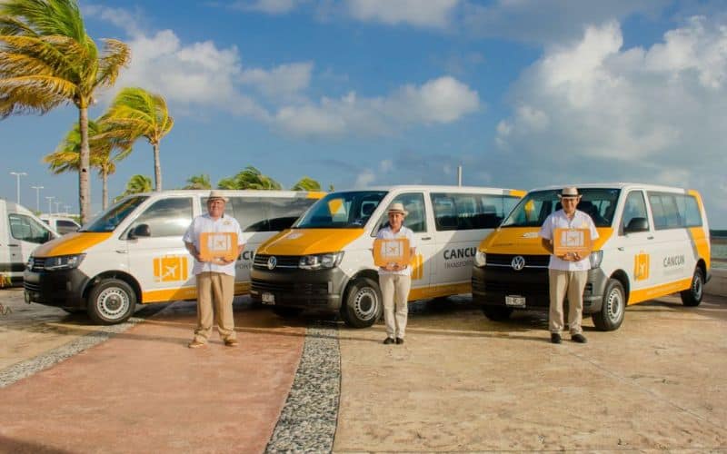 drivers in front of white vans from the best cancun to tulum shuttle service