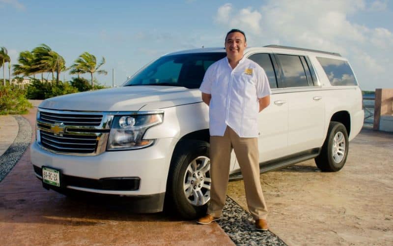 man in front of white SUV from the best cancun to tulum shuttle service