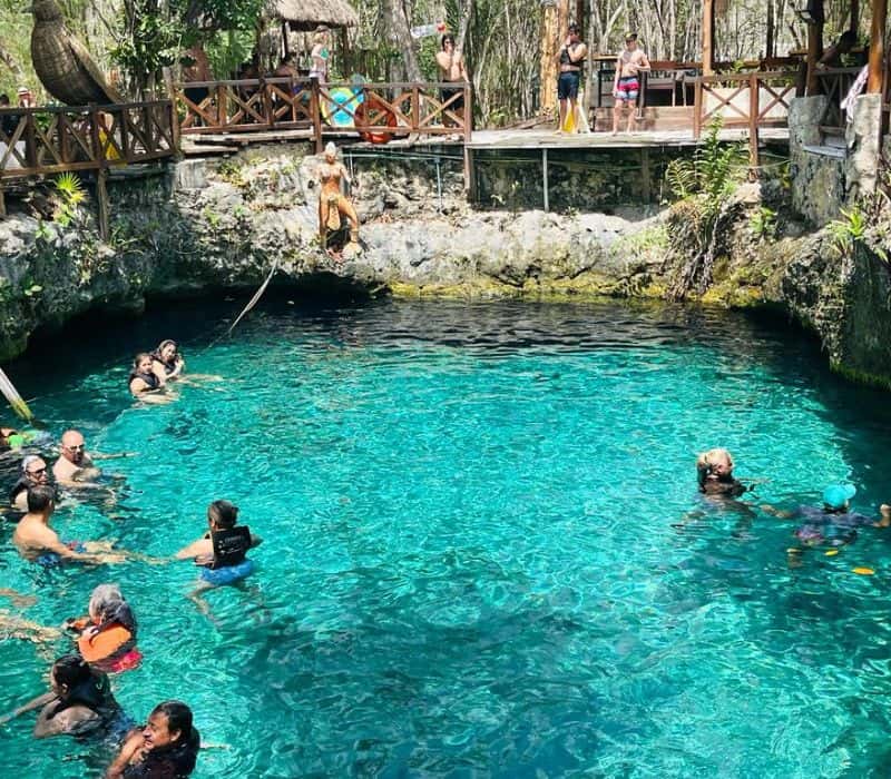 people swimming at cenote zazil ha