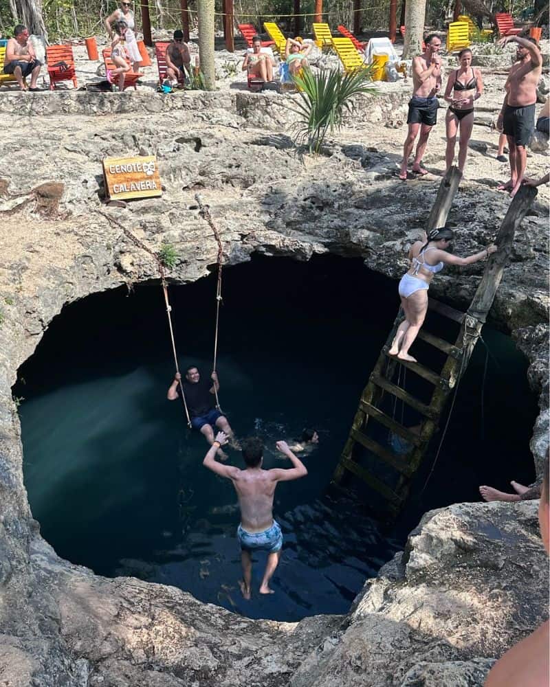man jumping into cenote calavera tulum