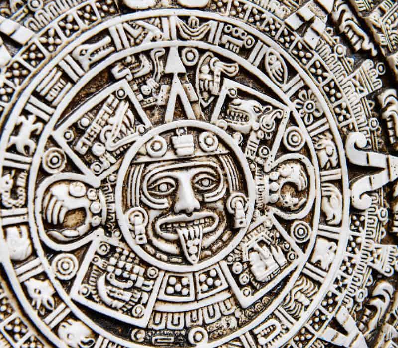 mayan calendar with the image of sun god in the middle