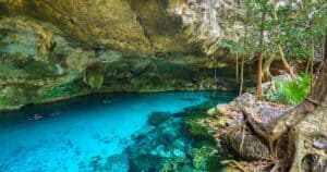 people swimming and snorkeling in cenote dos ojos tulum